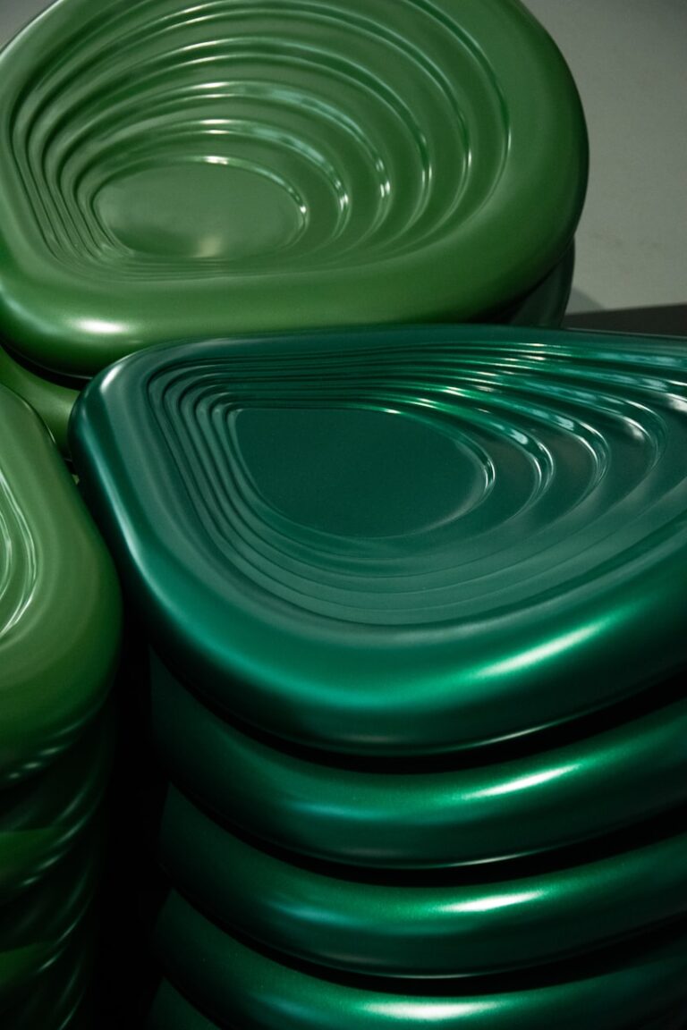 Green, shiny, and uniquely shaped chairs.