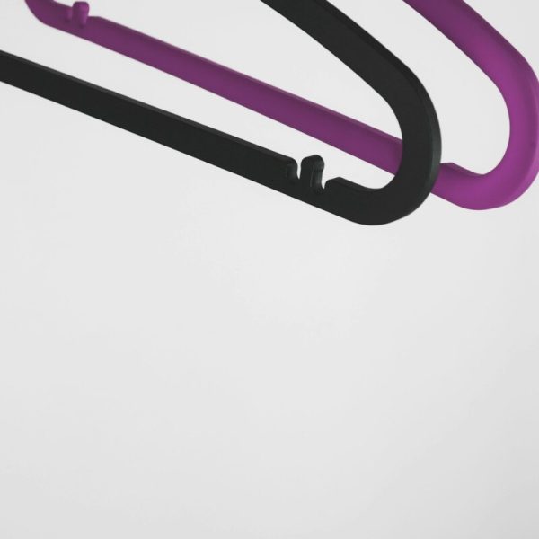 two black and purple plastic clothes hangers