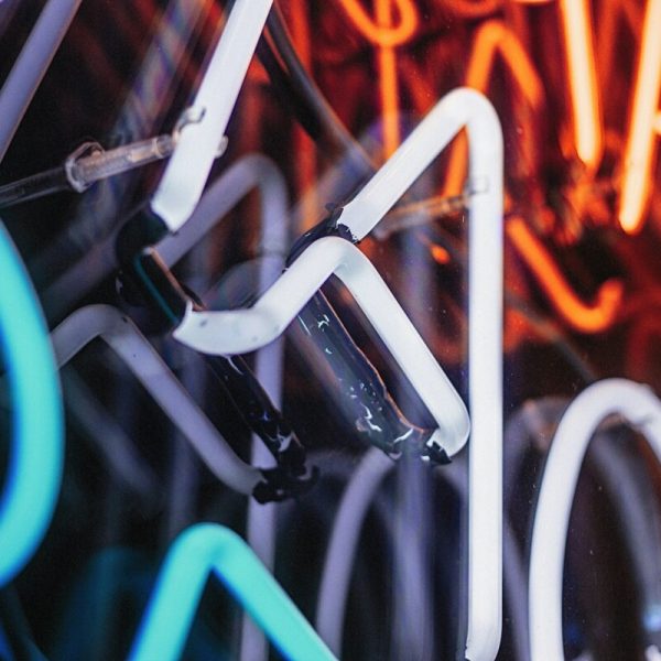 a close up of a neon sign on a wall