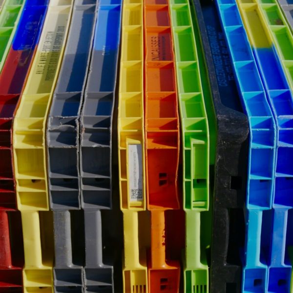 a bunch of different colored plastic containers stacked on top of each other
